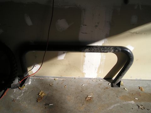 1994 Ford F-150 - Black metal object with text, mounted to a wall in a garage.