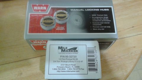 1996 Ford Bronco - A box of Warn manual locking hubs is shown in front of a Mile Marker product box. The Warn box displays "Manual Locking Hubs" and "Warn Lim…