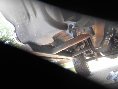 1994 Ford Bronco - Underside view of a vehicle, showing the fuel tank, exhaust system, and a tire. The vehicle appears to be a truck or SUV, possibly a 1994 F…