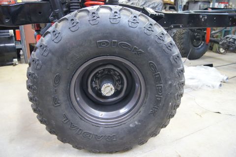 1979 Ford Bronco - Close-up of a large, off-road tire on a vehicle, showing the brand name "DICK CEPEK" and "RADIAL" printed on the sidewall. The tire is moun…