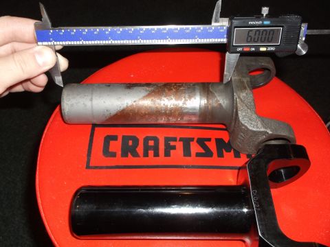 1999 Mercury Grand Marquis - A digital caliper measures the diameter of a metal shaft with rust spots. The caliper reads 6.000 mm/inch and is placed on a red Craftsman…