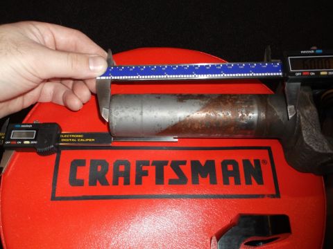 1999 Mercury Grand Marquis - A digital caliper measures the diameter of a metal part resting on a red Craftsman toolbox. The caliper reads 60.00 mm.