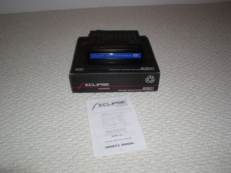 Eclipse 2301 car stereo unit on its box with owner's manual