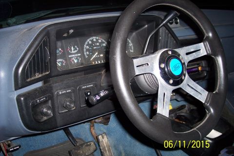 1990 Ford Bronco - Interior view of a 1990 Ford Bronco showing the dashboard, steering wheel, and center console. The dashboard features a speedometer, fuel g…