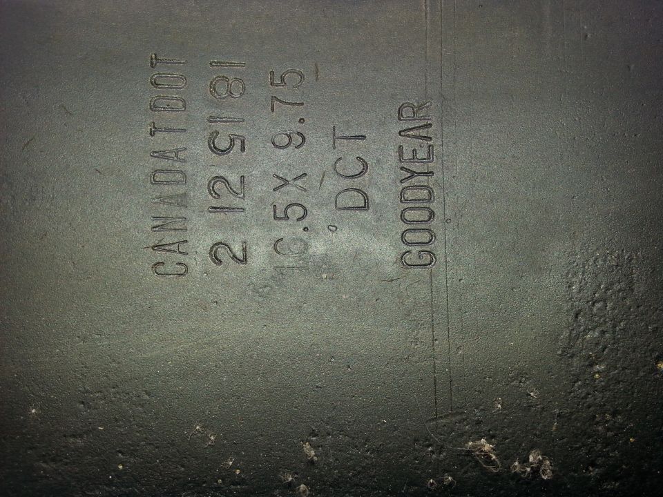 Embossed text on a tire: CANADA DOT 2 12 5181 16.5X 9.75 DCT GOODYEAR