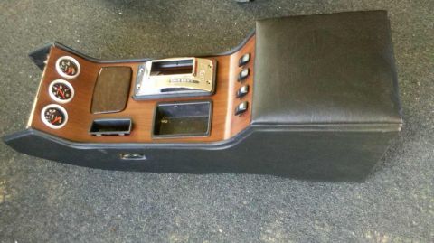 1982 Ford Bronco - A custom center console with wood grain trim, gauges, a radio bezel, and switches is shown from a front-right angle.