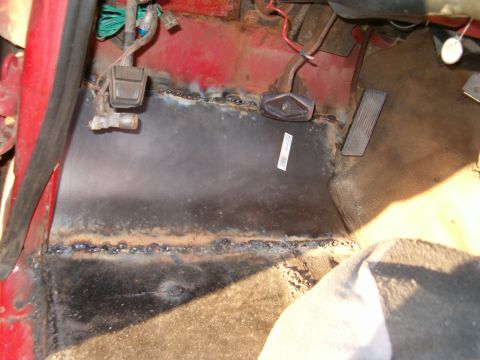 1979 Ford Bronco - The interior floor pan shows evidence of repair work, including fresh welds and the placement of the brake and accelerator pedals.