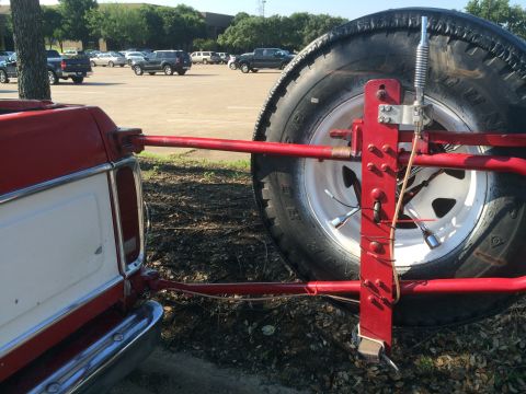 1979 Ford Bronco - Bent a CB Antenna mirror mount and attached to the spare tire holder.