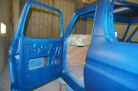 1979 Ford Bronco - The open driver's side door and interior of a blue vehicle, likely undergoing restoration or painting, are shown. The door jamb and interio…