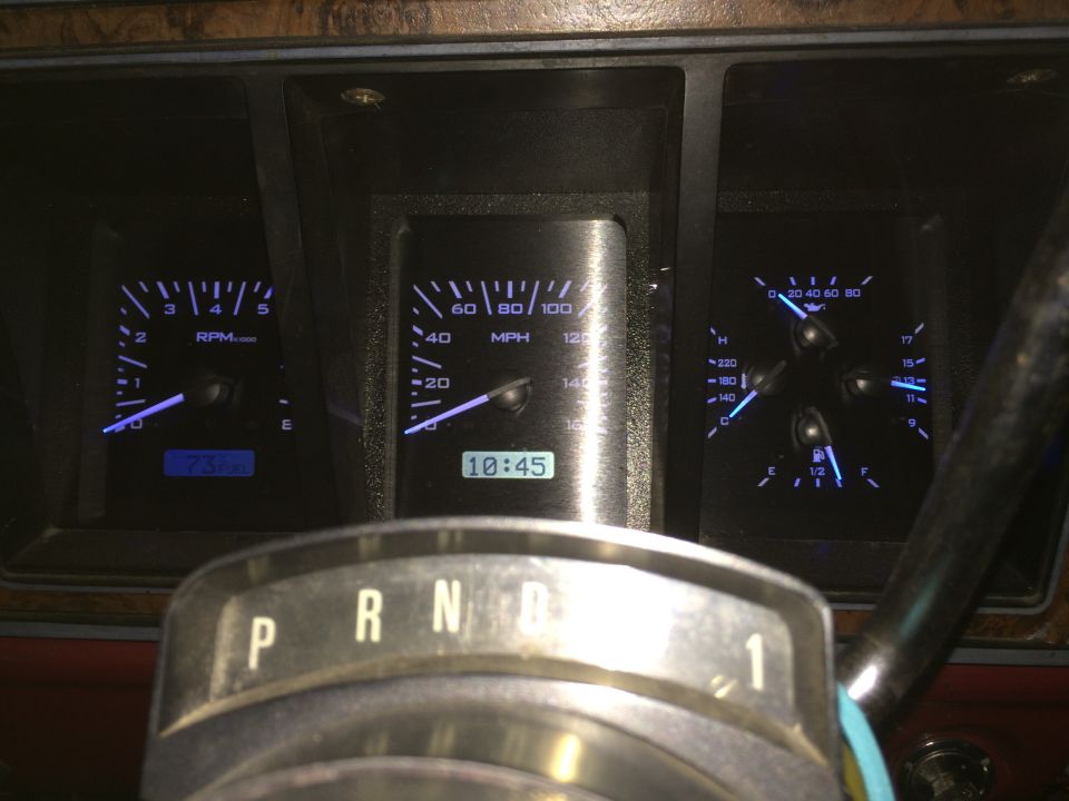 Vehicle dashboard with illuminated gauges and gear shifter
