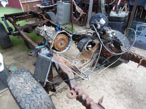 1993 Ford Bronco - The frame is nearly empty, but it still has to roll & steer so the trans/t-case can be removed.