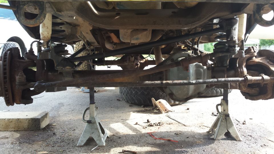 Underside view of a vehicle's front suspension and steering components.
