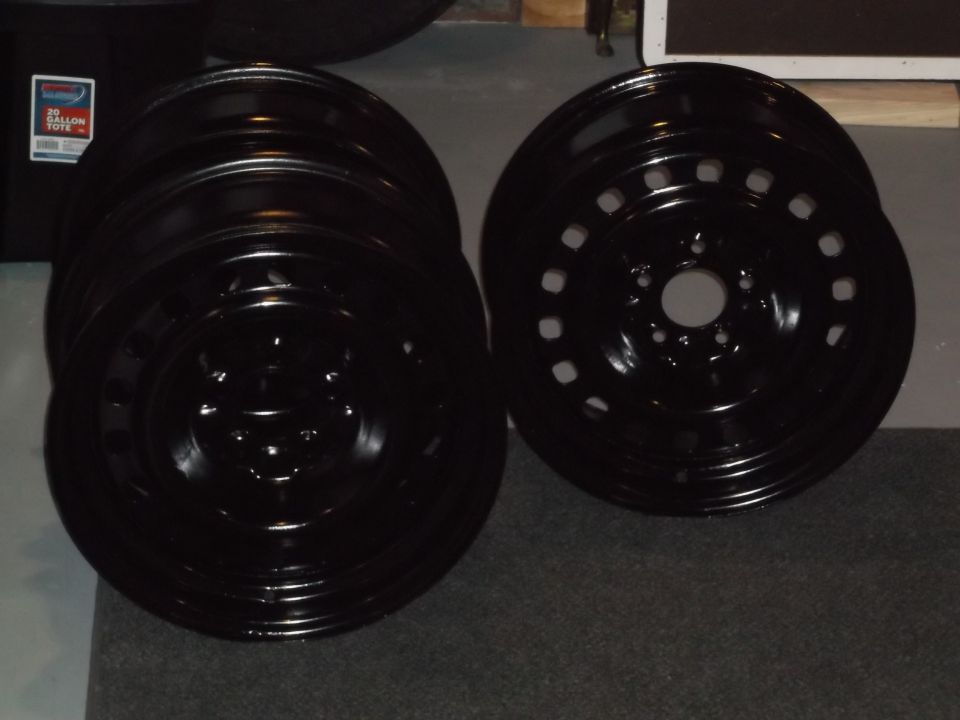 Stack of black steel wheels with a storage tote