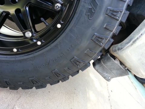 1994 Ford Bronco - A close-up shot focuses on the tread and sidewall of a large tire mounted on a black wheel.