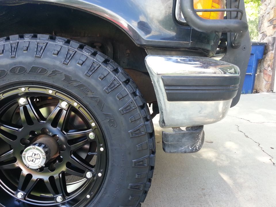 Black 1992 Ford Bronco front wheel and chrome bumper with black trim