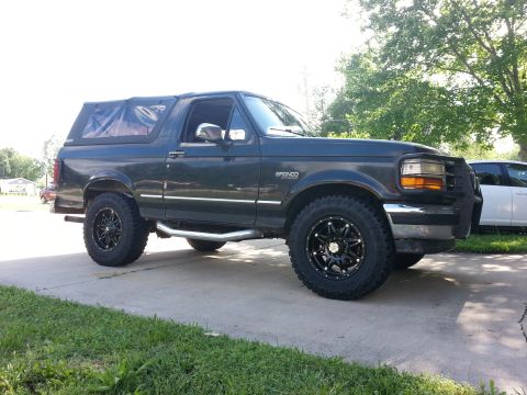 1994 Ford Bronco - This 1994 Ford Bronco is shown from the side, aftermarket wheels and a front brush guard.