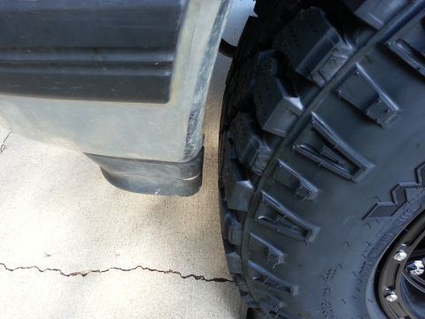 1994 Ford Bronco - A close-up view shows a vehicle's tire and fender flare, with visible text on the tire.