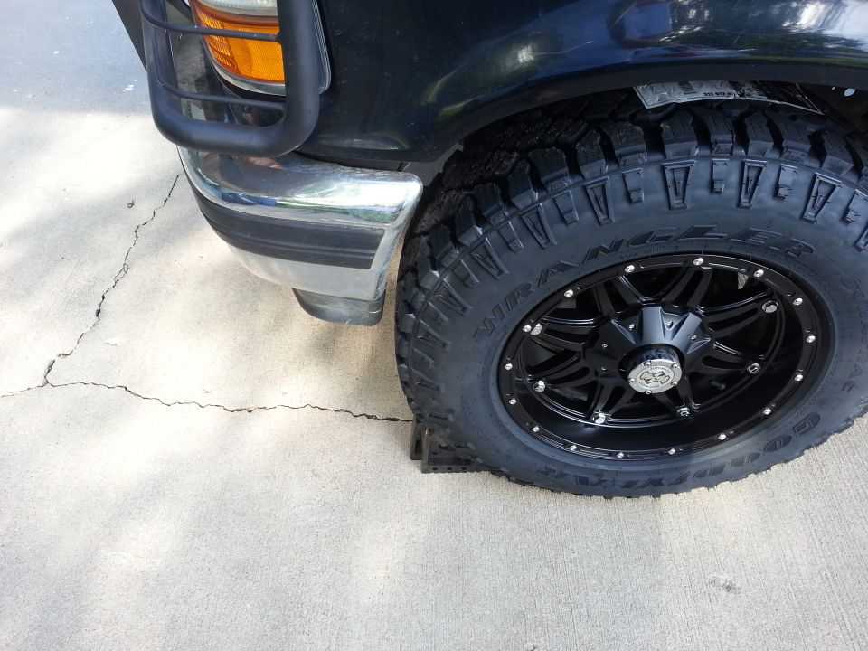Black 1994 Ford Bronco front wheel with chrome bumper and grille guard