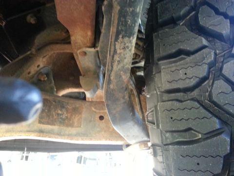 1994 Ford Bronco - A close-up view of a vehicle's undercarriage and tire, the SuperMotors.net logo at the bottom.