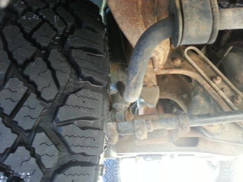 1994 Ford Bronco - Underside view of a vehicle's tire and suspension system, revealing mechanical details and wear.