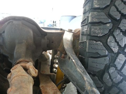 1994 Ford Bronco - Close-up view of the rear axle and tire assembly, showing suspension components.