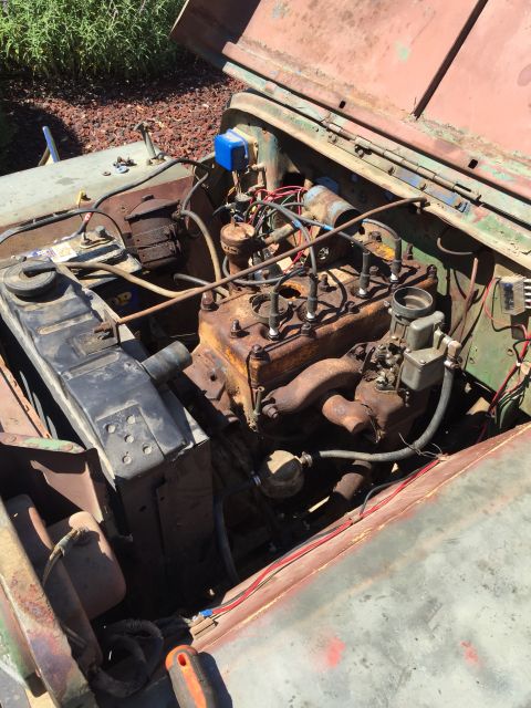 1946 Jeep Willys - Engine bay of a 1946 Jeep CJ5, showing the radiator, engine, and various components.