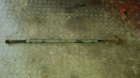 Metal tie rod end with a ball joint connection on one end and a rusted bracket on the other