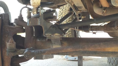 Undercarriage of a 1979 Ford Bronco showing suspension components and tire tread