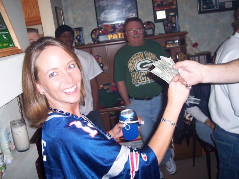 1990 Ford Bronco - People gathered indoors, with money being passed between two individuals.