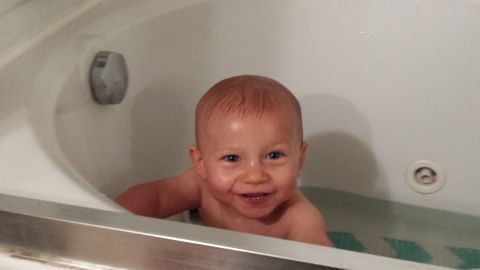 1979 Ford Bronco - A baby enjoys bath time, with a website logo visible in the corner of the tub.