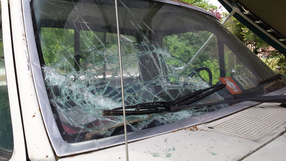 Front view of a truck with a shattered windshield. Wipers are visible on the glass