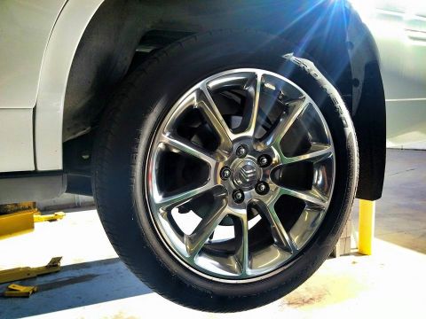 2000 Mercury Grand Marquis - A close-up view of a vehicle's wheel and tire, a chrome rim with the Mercury logo visible.