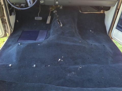 1979 Ford Bronco - The interior of a 1978 Ford Bronco shows black carpeting and visible floor bolts.