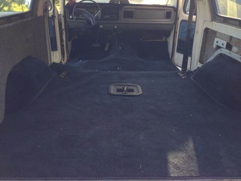 1979 Ford Bronco - The interior of a 1979 Ford Bronco is shown, the dashboard and a carpeted cargo space.