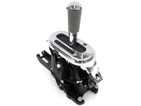 1995 Ford Bronco - This automatic transmission shifter assembly features a chrome bezel and a gray grip on the shifter handle.
