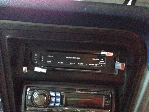 1979 Ford Bronco - Climate controls and stereo system visible inside a vehicle's cabin.