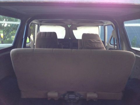 1979 Ford Bronco - The rear seating area of a vehicle is visible, with windows showing an outdoor scene.