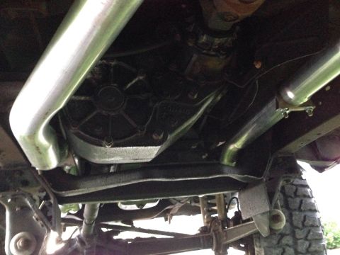 1979 Ford Bronco - Undercarriage view showing drivetrain components and exhaust pipes, watermarked by Supermotors.net.
