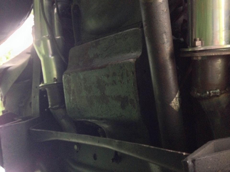 Close-up of vehicle undercarriage showing frame and exhaust pipe