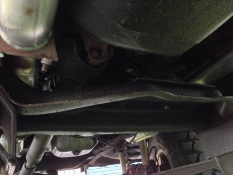 1979 Ford Bronco - This photo shows the undercarriage of a vehicle, including its frame, suspension components, and exhaust pipe.