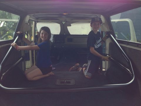 1979 Ford Bronco - Children sit inside a 1978 Ford Bronco, which has been modified with a roll cage.
