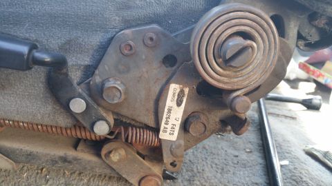1995 Ford F-150 - A close-up view of a vehicle's seat adjustment mechanism, showing its internal components and springs.