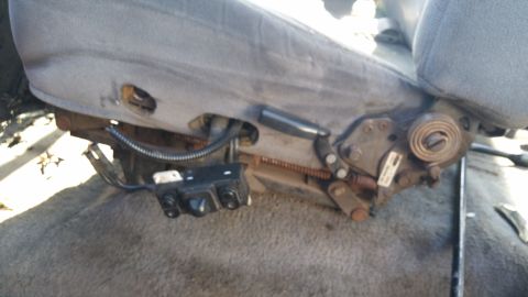 1995 Ford F-150 - Close-up of a car seat's internal mechanism, showing power adjustment controls and springs.