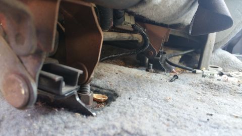 1995 Ford F-150 - Vehicle seat mounting hardware visible on the floor.