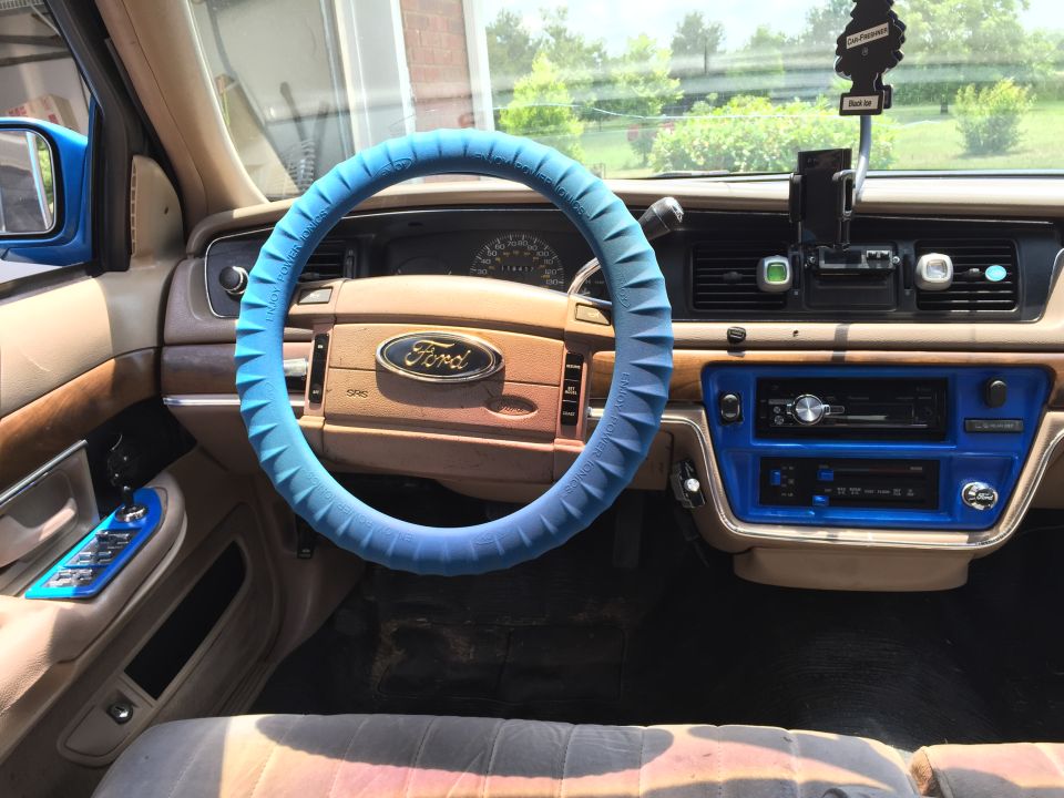 Interior of a 1994 Ford Crown Victoria showing dashboard, steering wheel, and center console