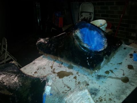 1996 Ford Bronco - A dark, wet fiberglass mold with a blue resin insert sits on a workbench, with a "Supermotors.net" watermark visible.
