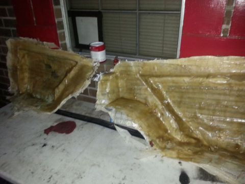 1996 Ford Bronco - Unfinished fiberglass body panels are shown on a workbench.