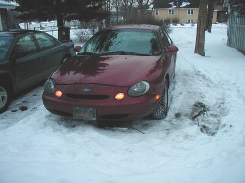 1997 Ford Taurus - Maroon 1997 Ford Taurus sits in a snowy driveway next to another vehicle.