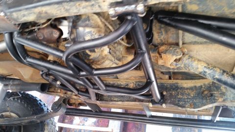 1988 Ford Bronco - Custom roll cage and suspension components are visible on the underbody of this off-road vehicle.