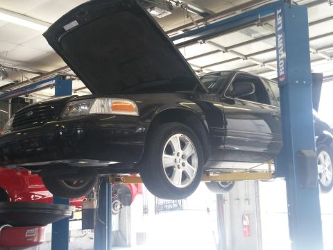 2000 Mercury Grand Marquis - Black 2000 Mercury Grand Marquis undergoing service on a two-post rotary lift.